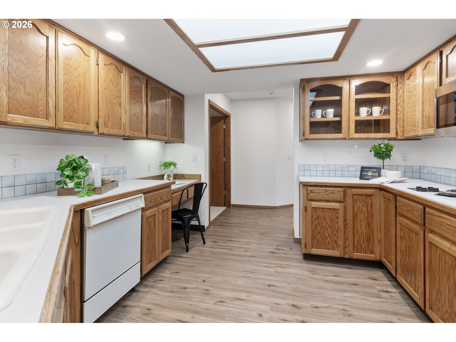 2730 Northeast Roberts Avenue Gresham, OR 97030 - Photo 12 of 43 a kitchen with granite countertop wooden cabinets a sink a window and stainless steel appliances
