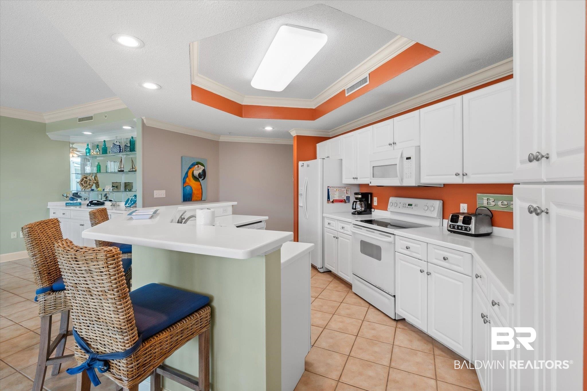 27580 Canal Road, Unit 1423 Orange Beach, AL 36561 - Photo 7 of 34 Kitchen featuring an island, a tray ceiling, light tile patterned floors and recessed lighting.