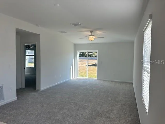 an empty room with windows and closet