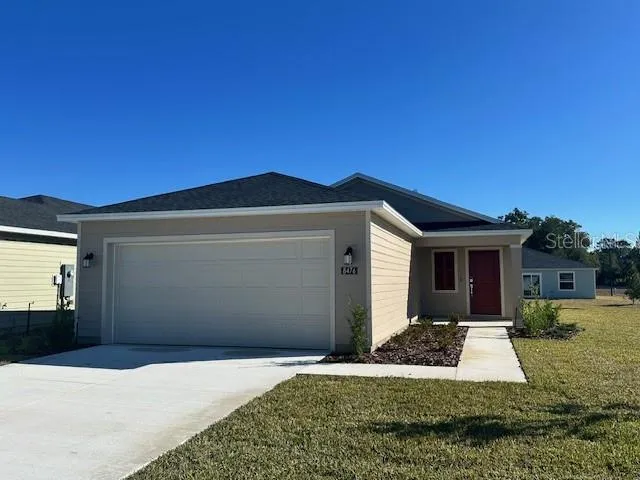 a front view of a house with yard and garage