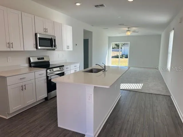 a view of a kitchen with electric appliances