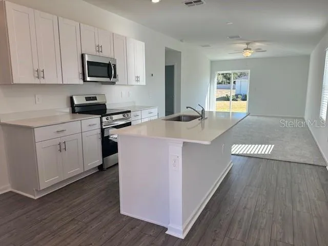a kitchen with a sink stove and cabinets