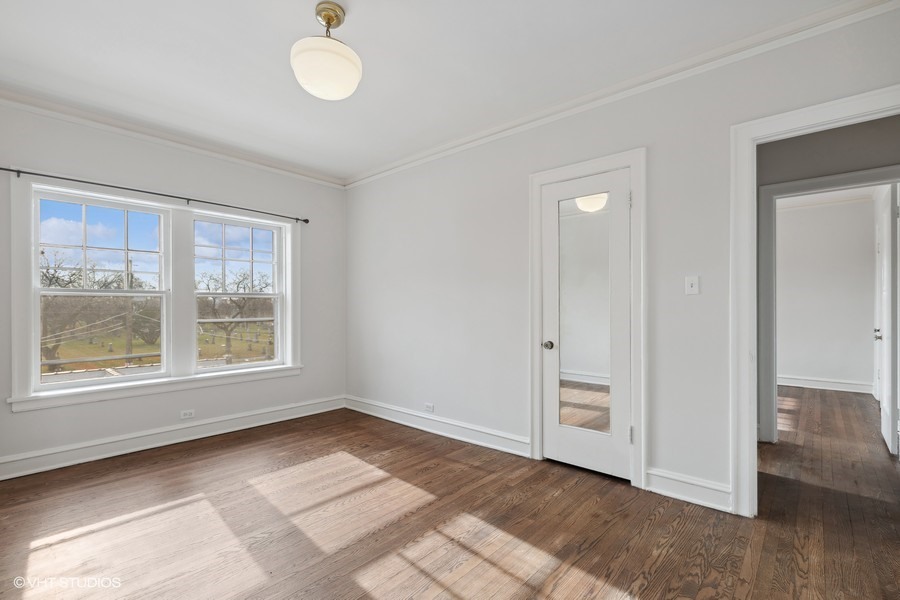 478 Sheridan Road, Unit 2 Evanston, IL 60202 - Photo 11 of 16 a view of an empty room with a window and wooden floor