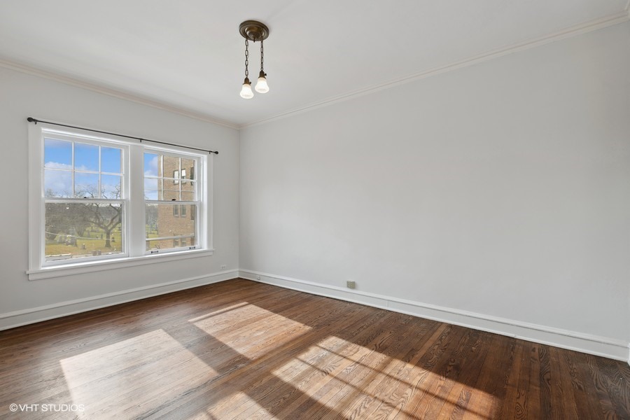 478 Sheridan Road, Unit 2 Evanston, IL 60202 - Photo 13 of 16 wooden floor in an empty room with a window