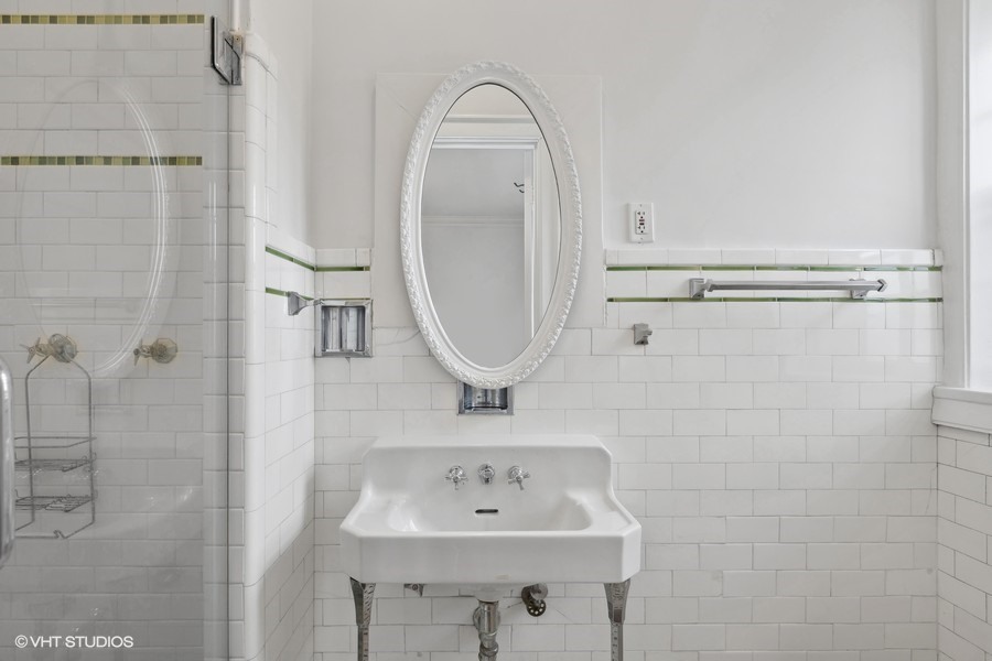478 Sheridan Road, Unit 2 Evanston, IL 60202 - Photo 5 of 16 a bathroom with a sink a toilet and a mirror