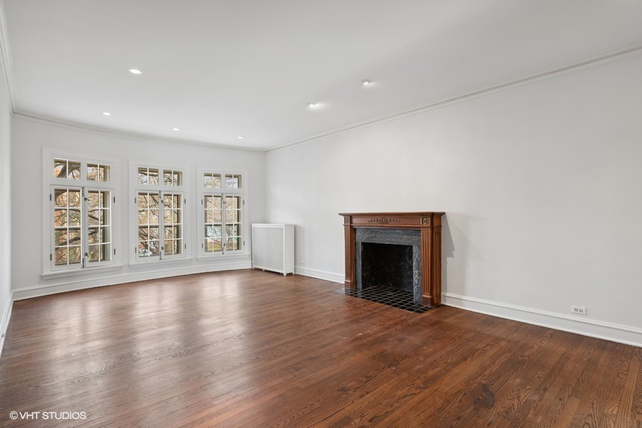 478 Sheridan Road, Unit 2 Evanston, IL 60202 - Photo 6 of 16 a view of an empty room with a fireplace and wooden floor