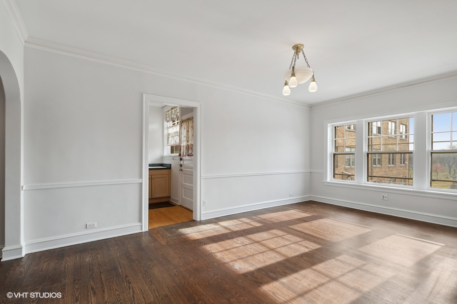478 Sheridan Road, Unit 2 Evanston, IL 60202 - Photo 9 of 16 an empty room with wooden floor cabinet and windows
