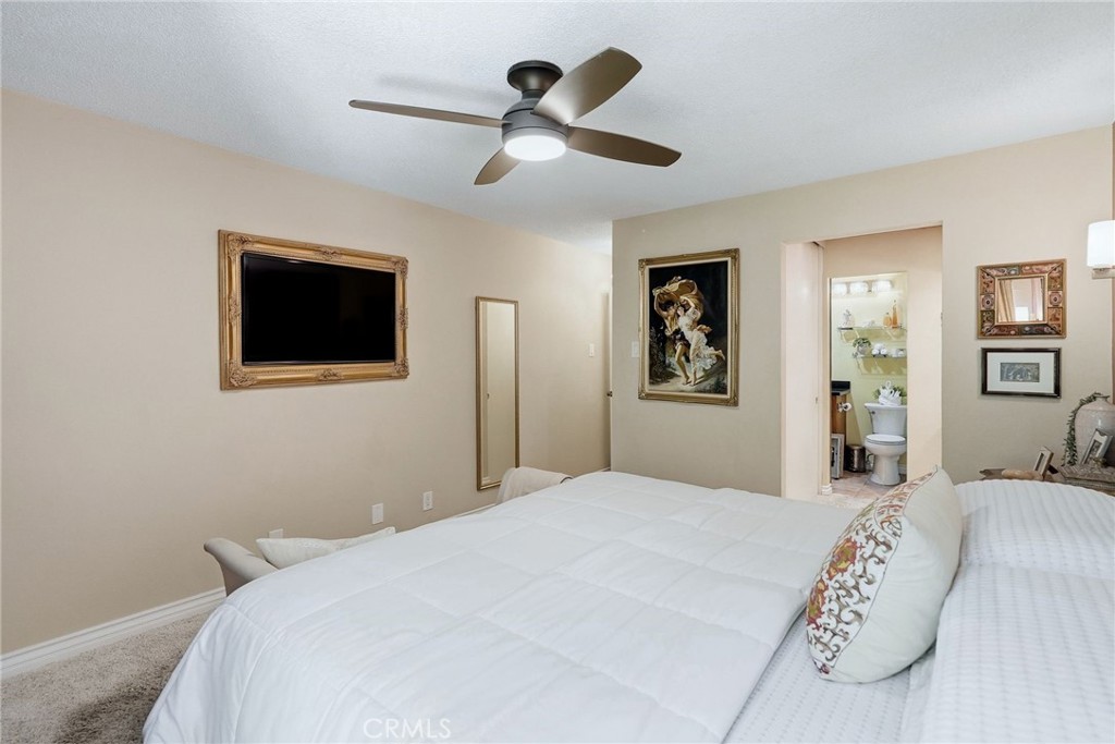 7890 East Spring Street, Unit 2L Long Beach, CA 90815 - Photo 22 of 47 a bedroom with a bed and a flat screen tv