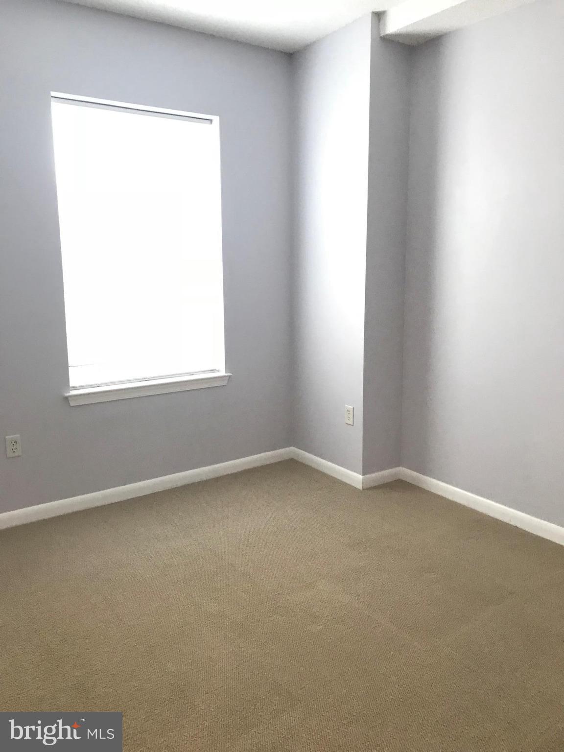 1111 11th Street Northwest, Unit 510 Washington, DC 20001 - Photo 10 of 13 an empty room with a window