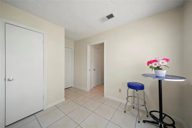 a view of an entryway with a flower pot and a bookshelf