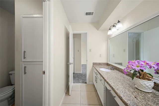 a hallway with granite countertop a sink dishwasher stove and refrigerator