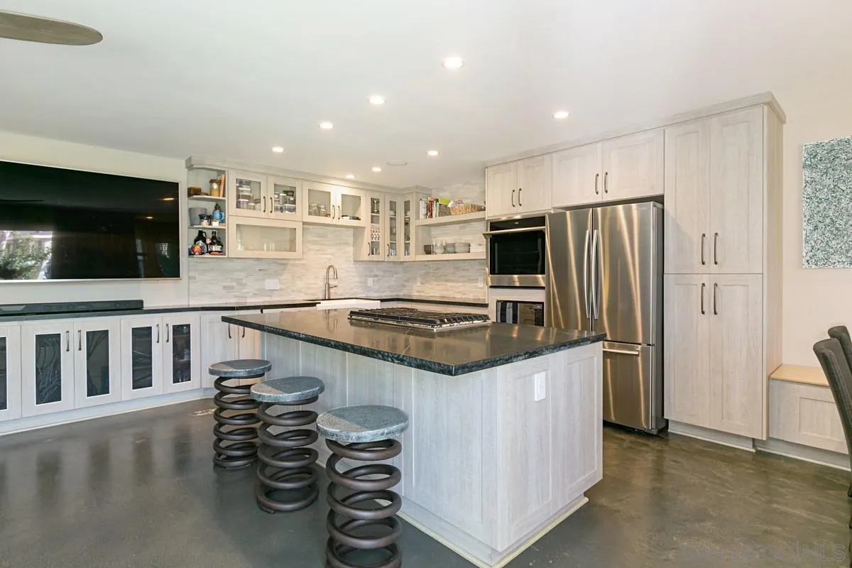 450 Summer View Circle Encinitas, CA 92024 - Photo 14 of 30 a kitchen with stainless steel appliances a refrigerator a stove a sink and a oven with wooden floor