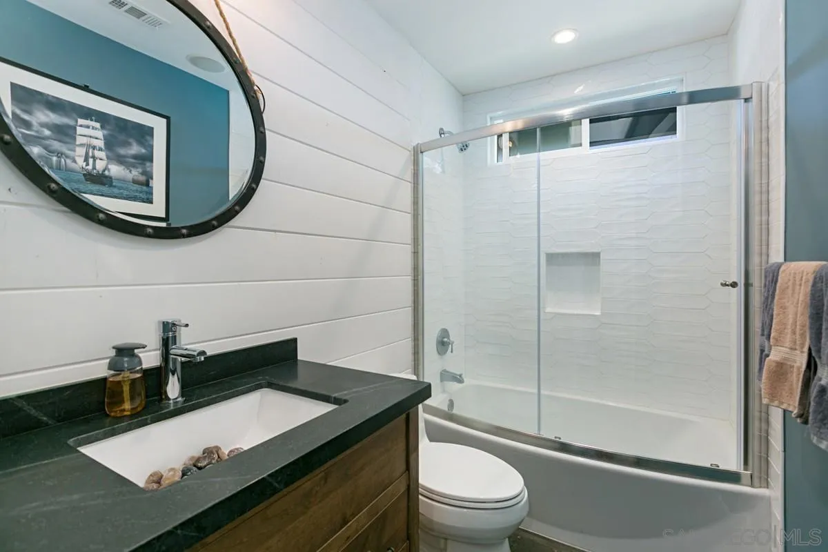 450 Summer View Circle Encinitas, CA 92024 - Photo 22 of 30 a bathroom with a granite countertop sink toilet a mirror and shower
