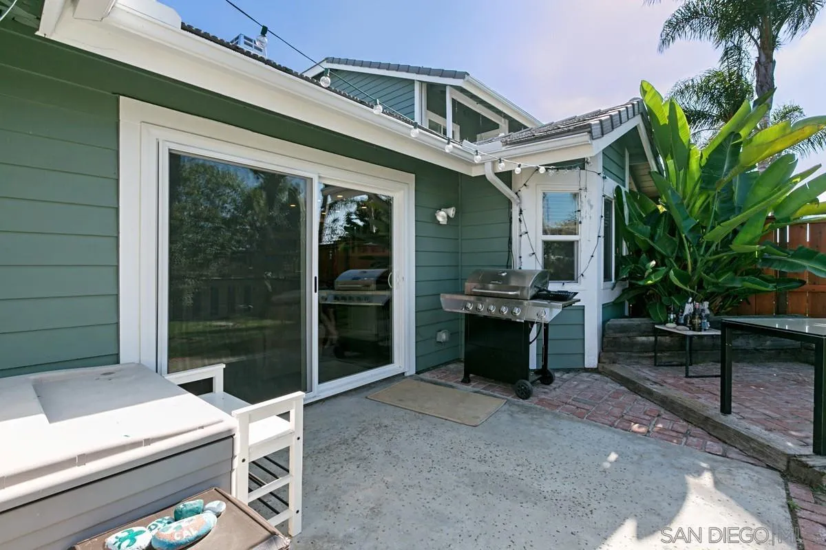 450 Summer View Circle Encinitas, CA 92024 - Photo 23 of 30 a view of a patio with table and chairs with wooden floor and fence
