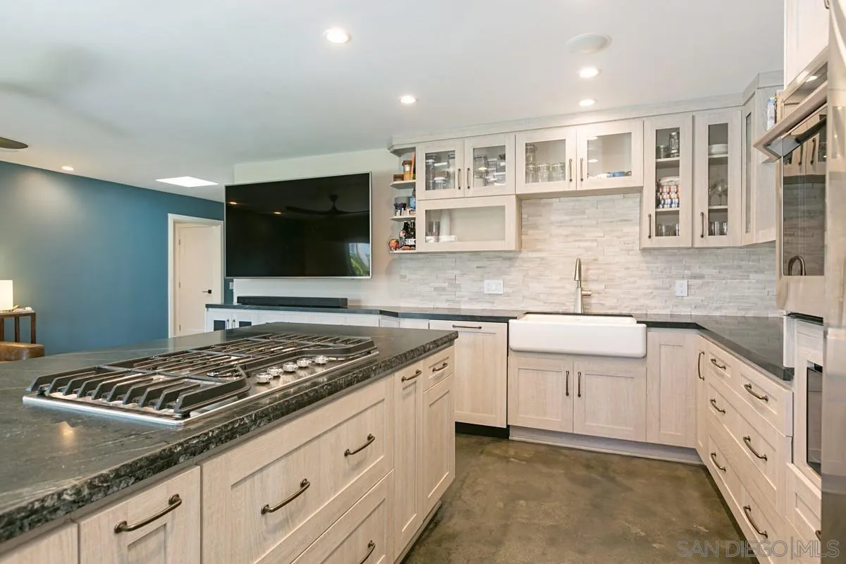 450 Summer View Circle Encinitas, CA 92024 - Photo 10 of 30 a kitchen with granite countertop white cabinets and white appliances
