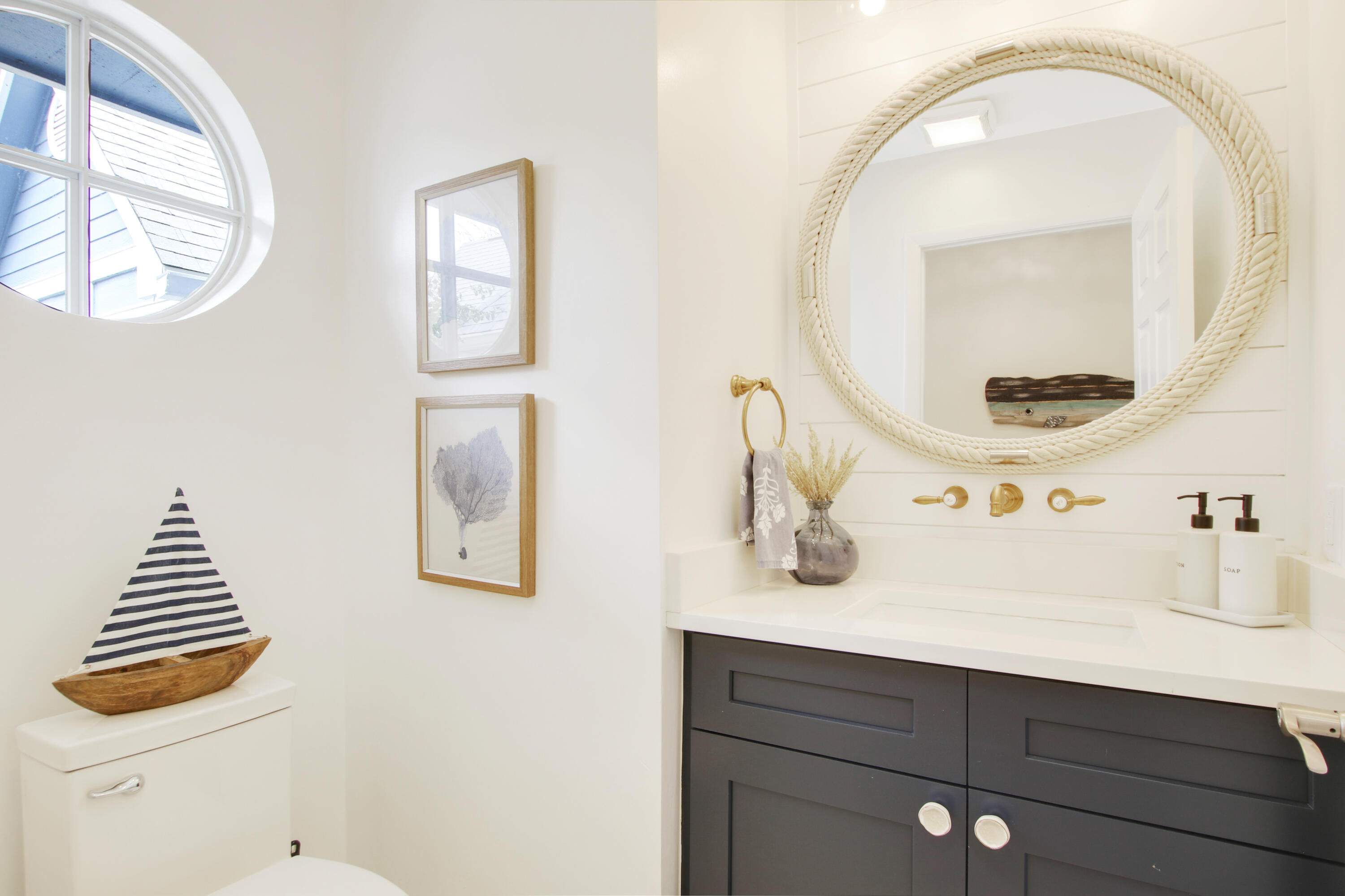 1219 Ocean Dunes Circle Jupiter, FL 33477 - Photo 4 of 32 a bathroom with a sink and a mirror