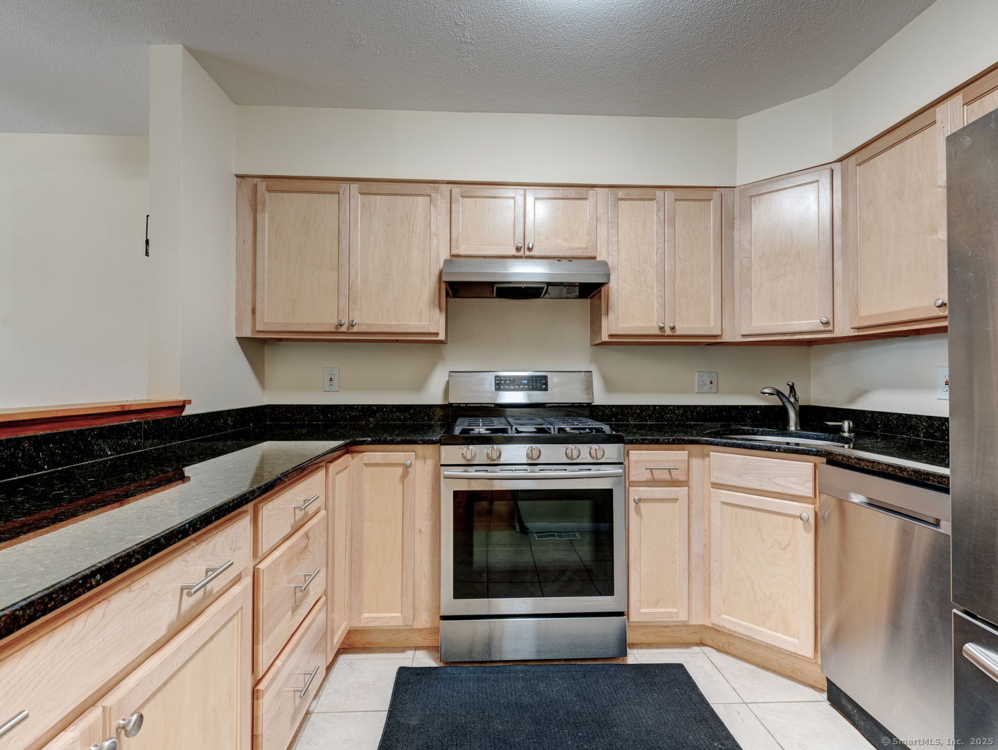 122 Cottonwood Road, Unit 122 Newington, CT 06111 - Photo 11 of 31 a kitchen with stainless steel appliances granite countertop a stove and white cabinets