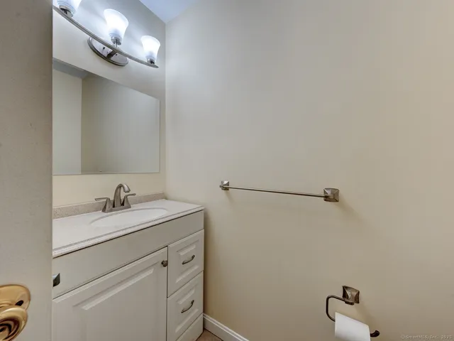 a bathroom with a sink vanity and a mirror