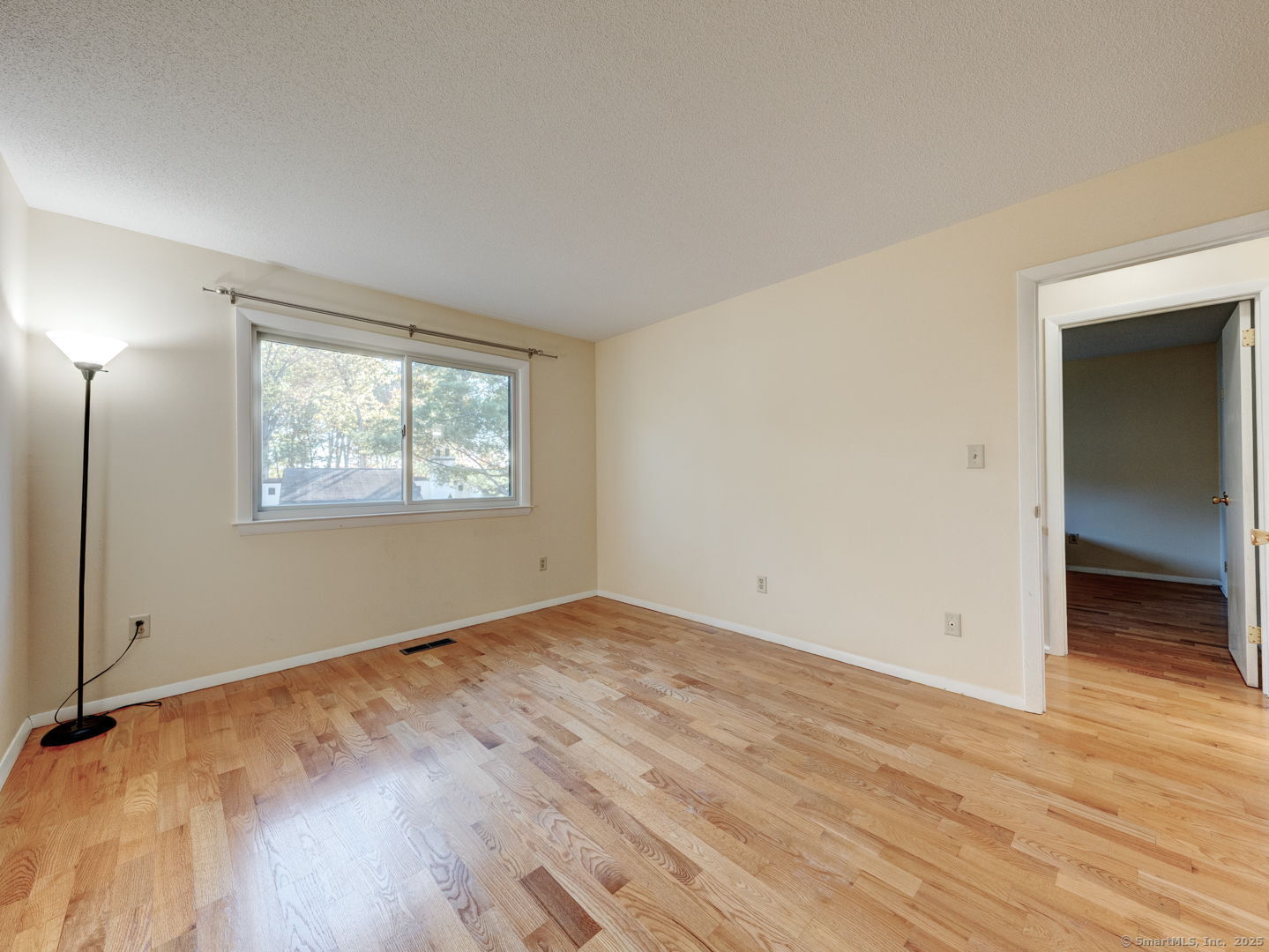 122 Cottonwood Road, Unit 122 Newington, CT 06111 - Photo 24 of 31 an empty room with wooden floor closet and windows