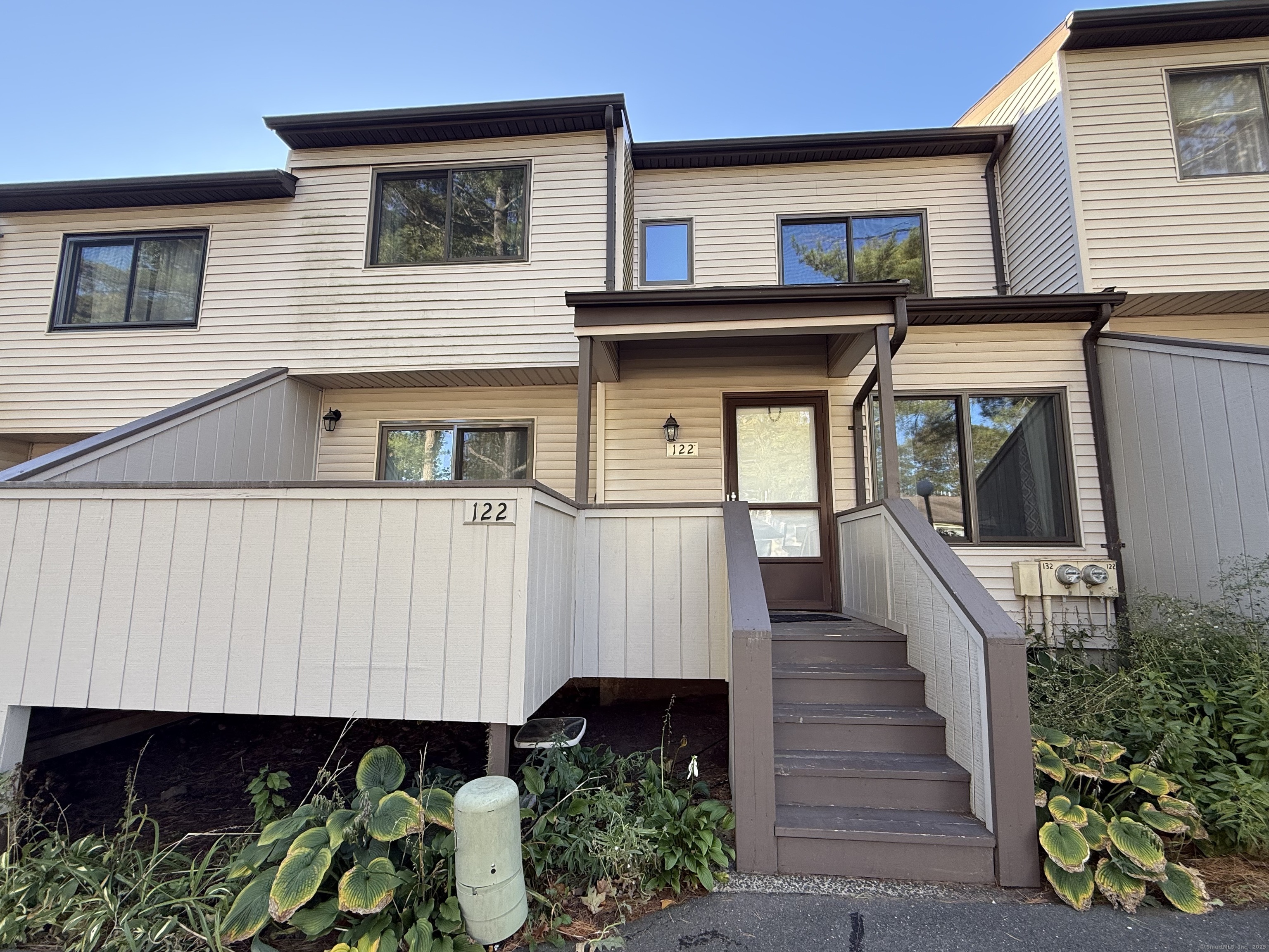 122 Cottonwood Road, Unit 122 Newington, CT 06111 - Photo 3 of 31 a front view of a house with entryway