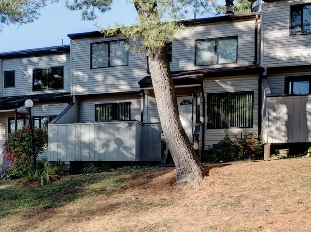 a view of a house with a wooden deck