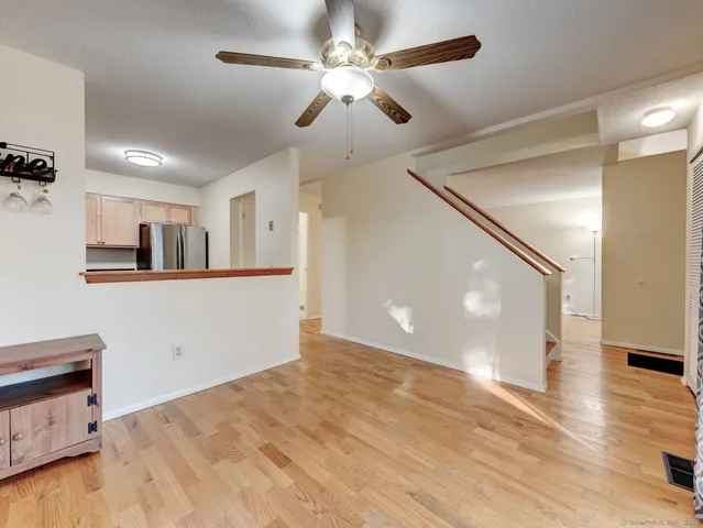 a view of a kitchen with furniture and a ceiling fan