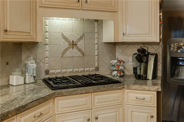 2988 Polo Club Road Nashville, TN 37221 - Photo 6 of 20 Custom tile backsplash in kitchen over the gas cooktop