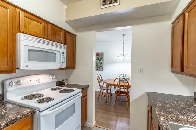 a kitchen that has a stove and a table