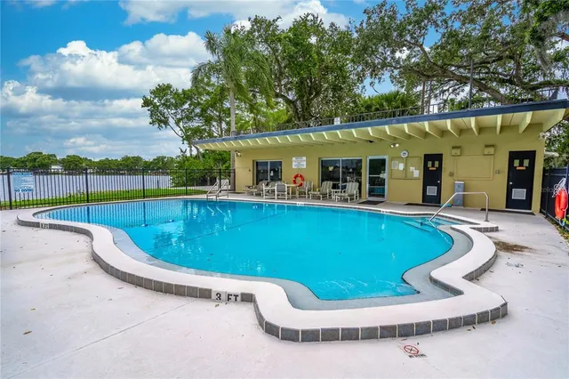 a view of a house with swimming pool and sitting area