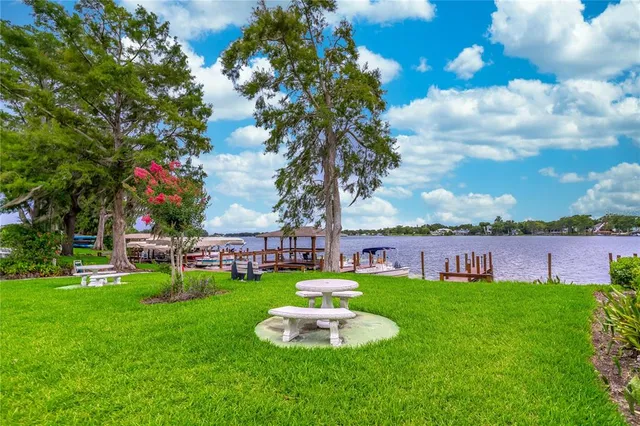 a backyard of a house with table and chairs