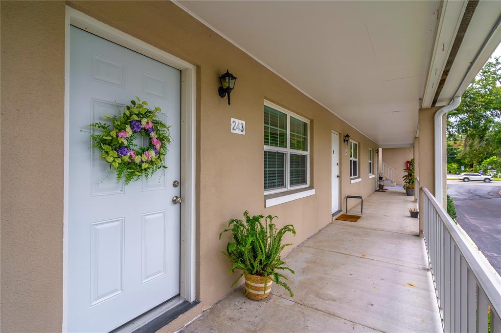 2500 Lee Road, Unit 243 Winter Park, FL 32789 - Photo 4 of 28 a house with potted plants in front of door