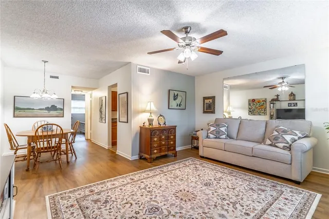 a living room with furniture and a chandelier