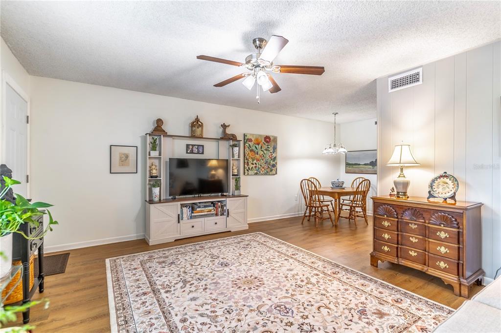 2500 Lee Road, Unit 243 Winter Park, FL 32789 - Photo 6 of 28 a living room with furniture and a flat screen tv