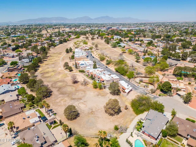 an aerial view of a houses with a yard