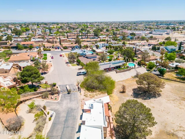 an aerial view of residential houses with outdoor space and river