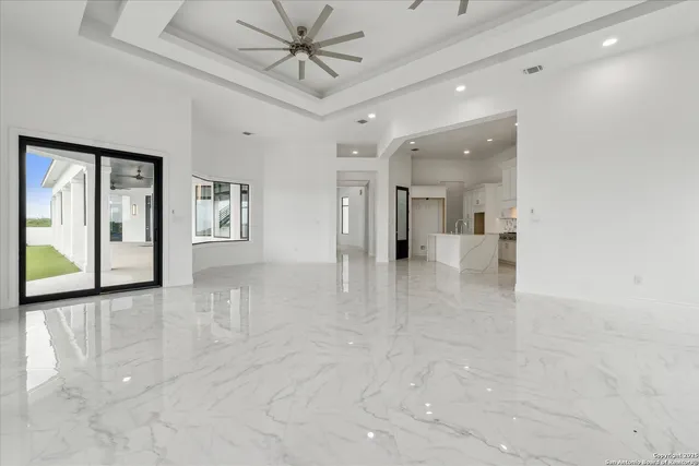 a view of an empty room with a window and closet