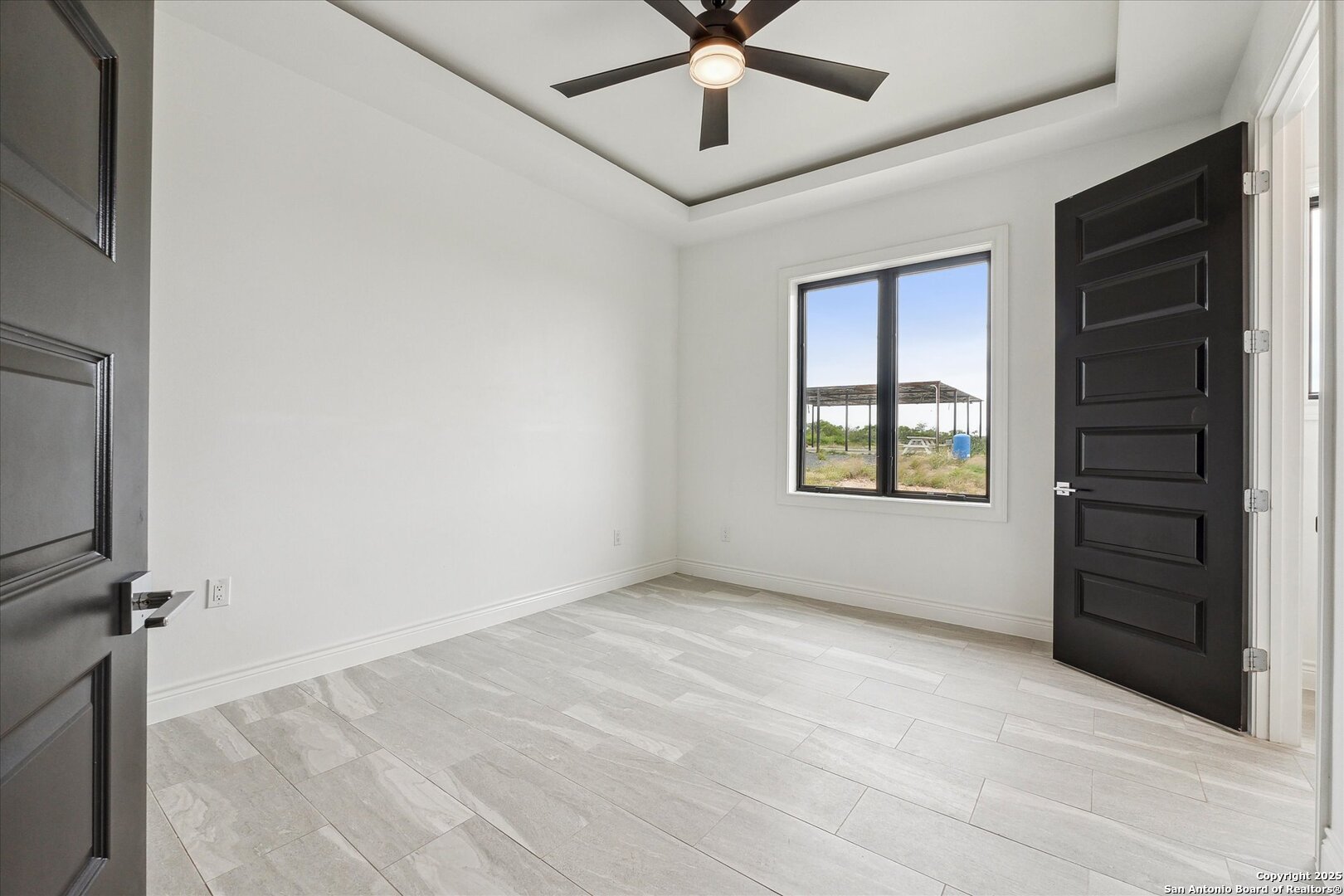 1799 County Road 651 Devine, TX 78016 - Photo 20 of 72 a view of an empty room with a window and closet