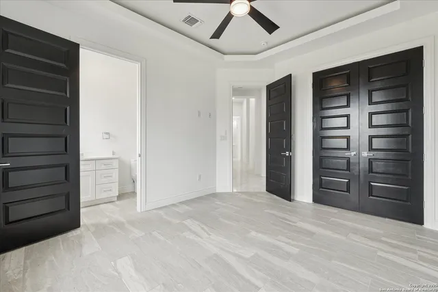 a spacious bathroom with a double vanity sink a mirror and a bathtub