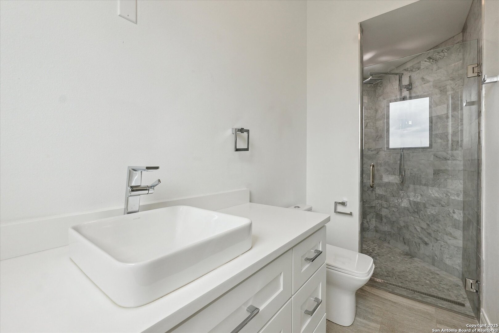 1799 County Road 651 Devine, TX 78016 - Photo 22 of 72 a bathroom with a sink toilet and shower