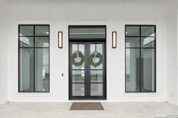 an empty room with windows and cabinet