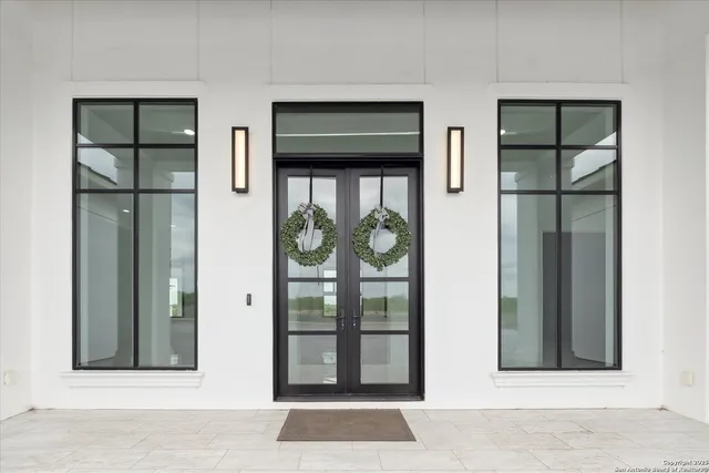 an empty room with windows and cabinet