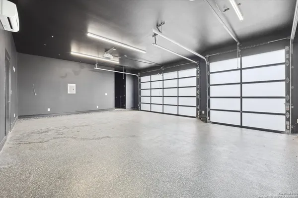 a view of a house with a swimming pool and wooden deck