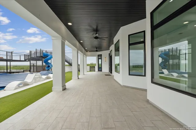 a view of an house with swimming pool and porch