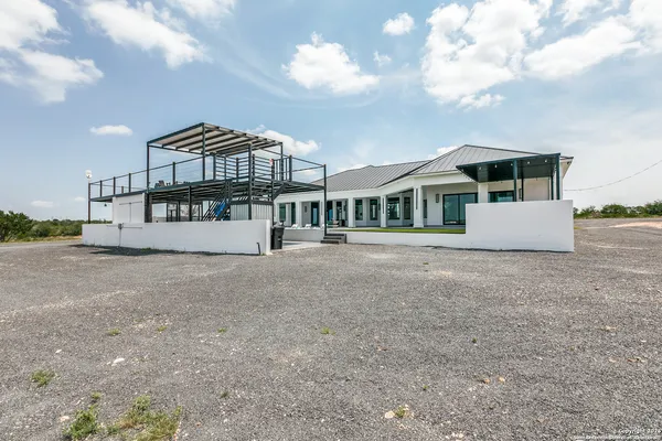 an aerial view of residential houses with outdoor space and ocean