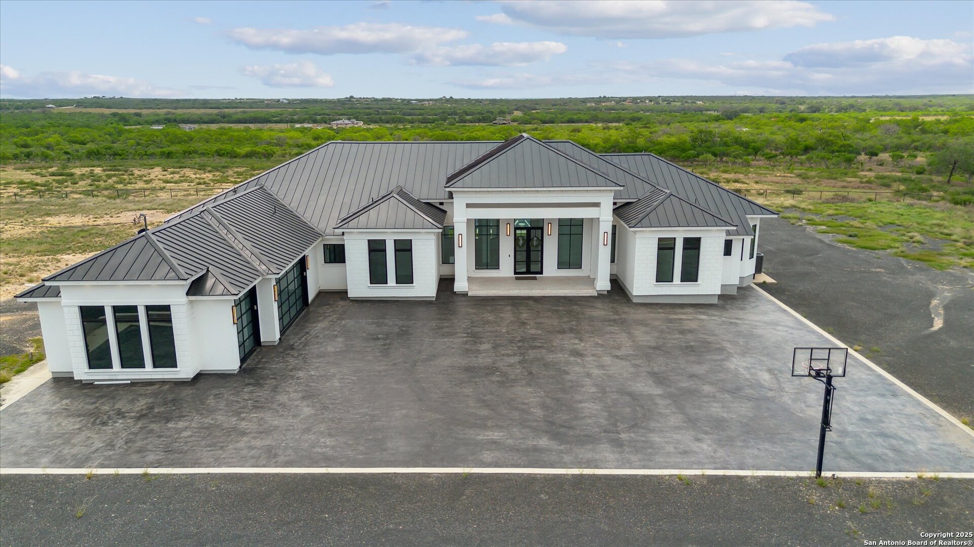 1799 County Road 651 Devine, TX 78016 - Photo 40 of 72 a front view of a house with a yard