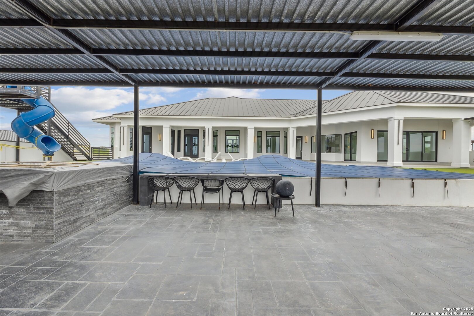1799 County Road 651 Devine, TX 78016 - Photo 48 of 72 a view of a house with wooden deck and furniture