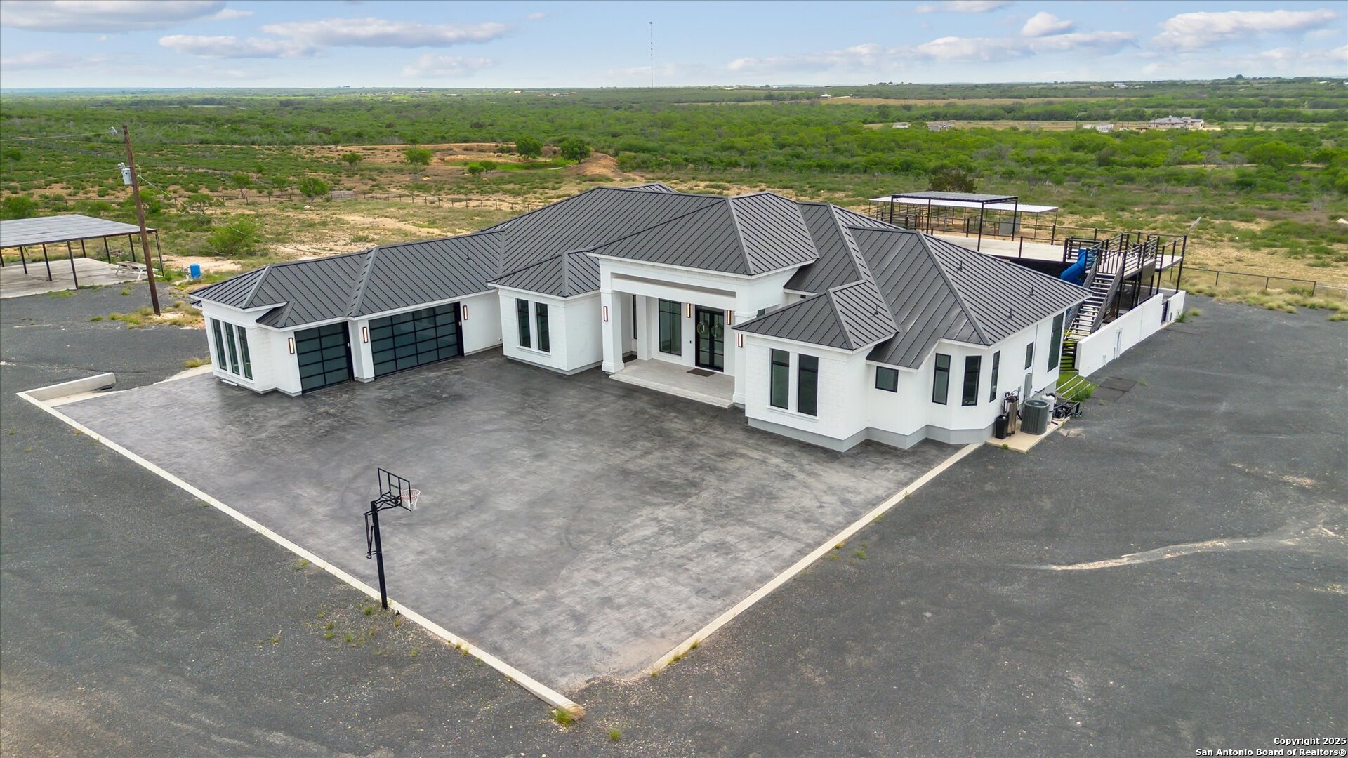 1799 County Road 651 Devine, TX 78016 - Photo 53 of 72 an aerial view of residential houses with outdoor space and ocean