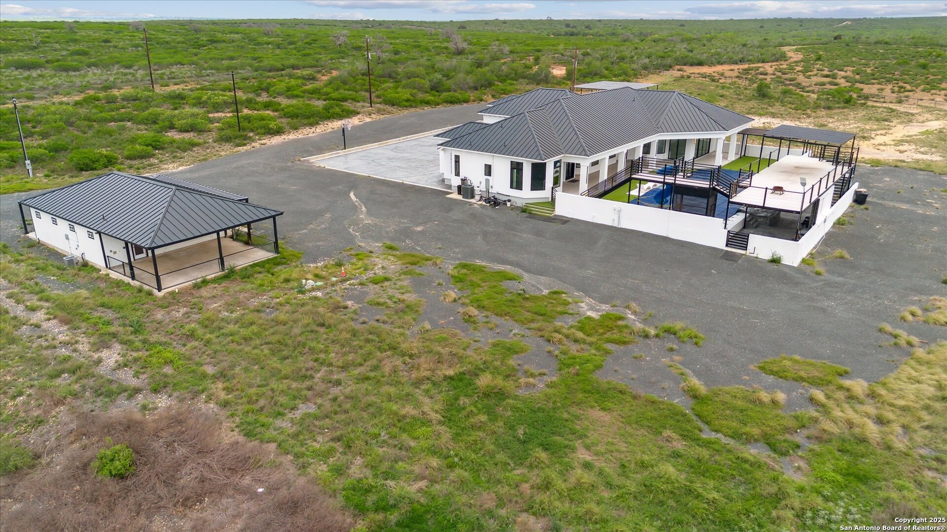 1799 County Road 651 Devine, TX 78016 - Photo 60 of 72 an aerial view of residential houses with outdoor space and ocean view