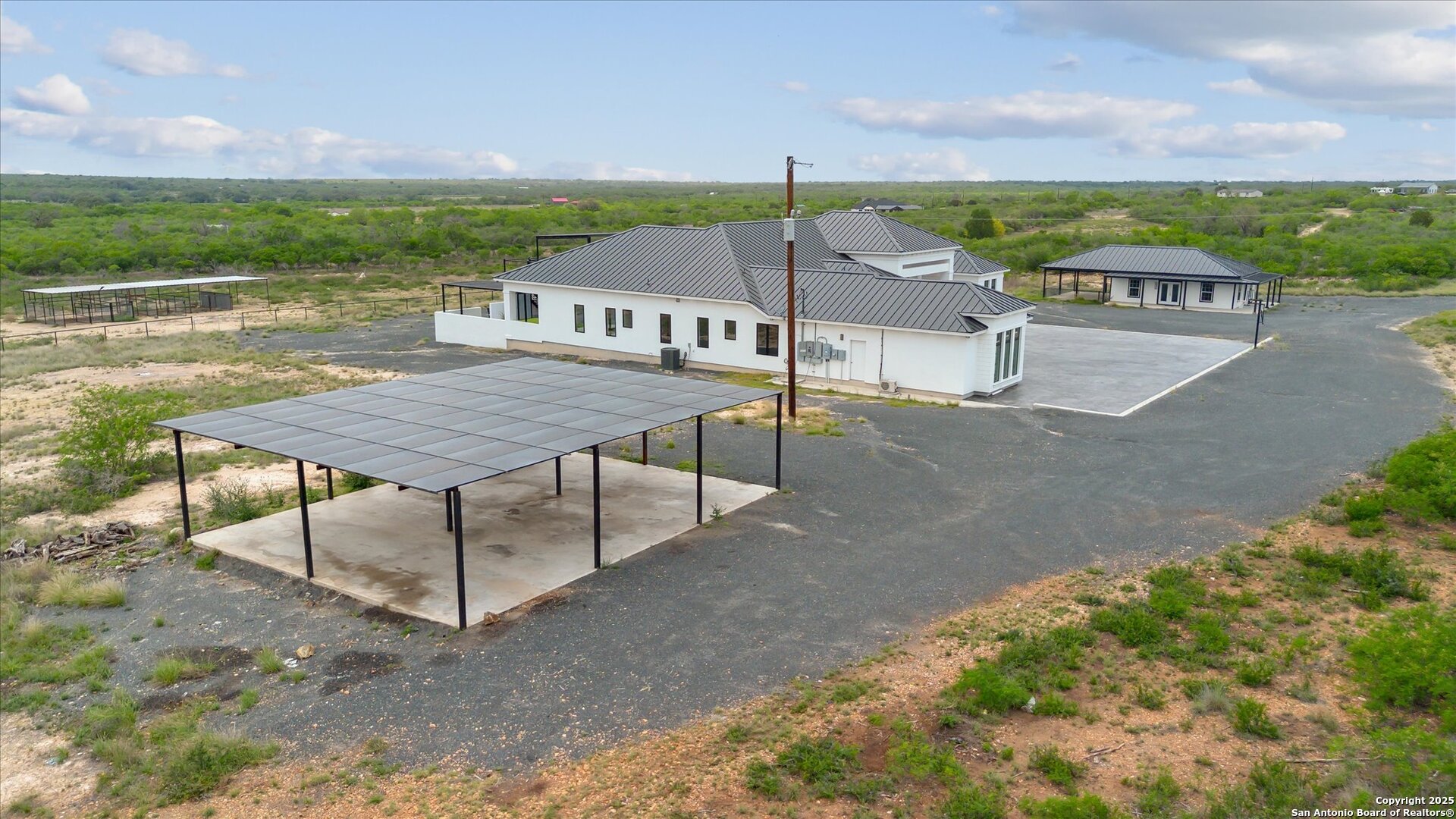 1799 County Road 651 Devine, TX 78016 - Photo 61 of 72 an aerial view of a house with a yard and furniture