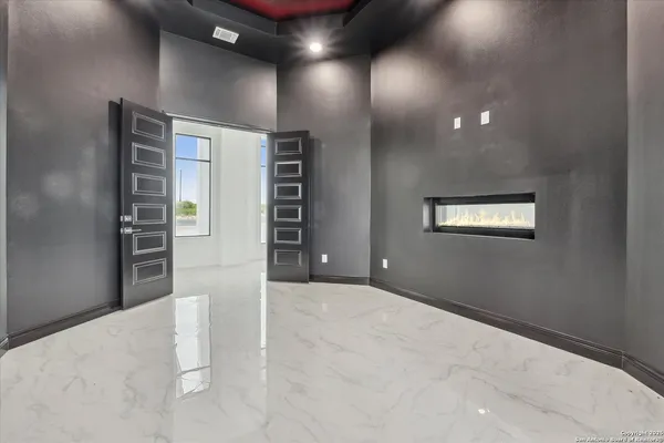 a kitchen with kitchen island granite countertop white cabinets white stainless steel appliances with a sink and dishwasher